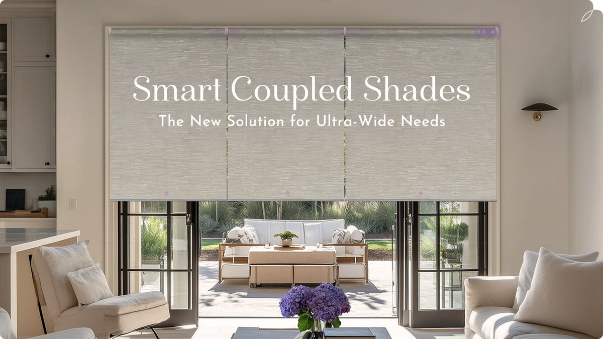 Living room with large smart coupled window shades covering glass doors, modern neutral decor.