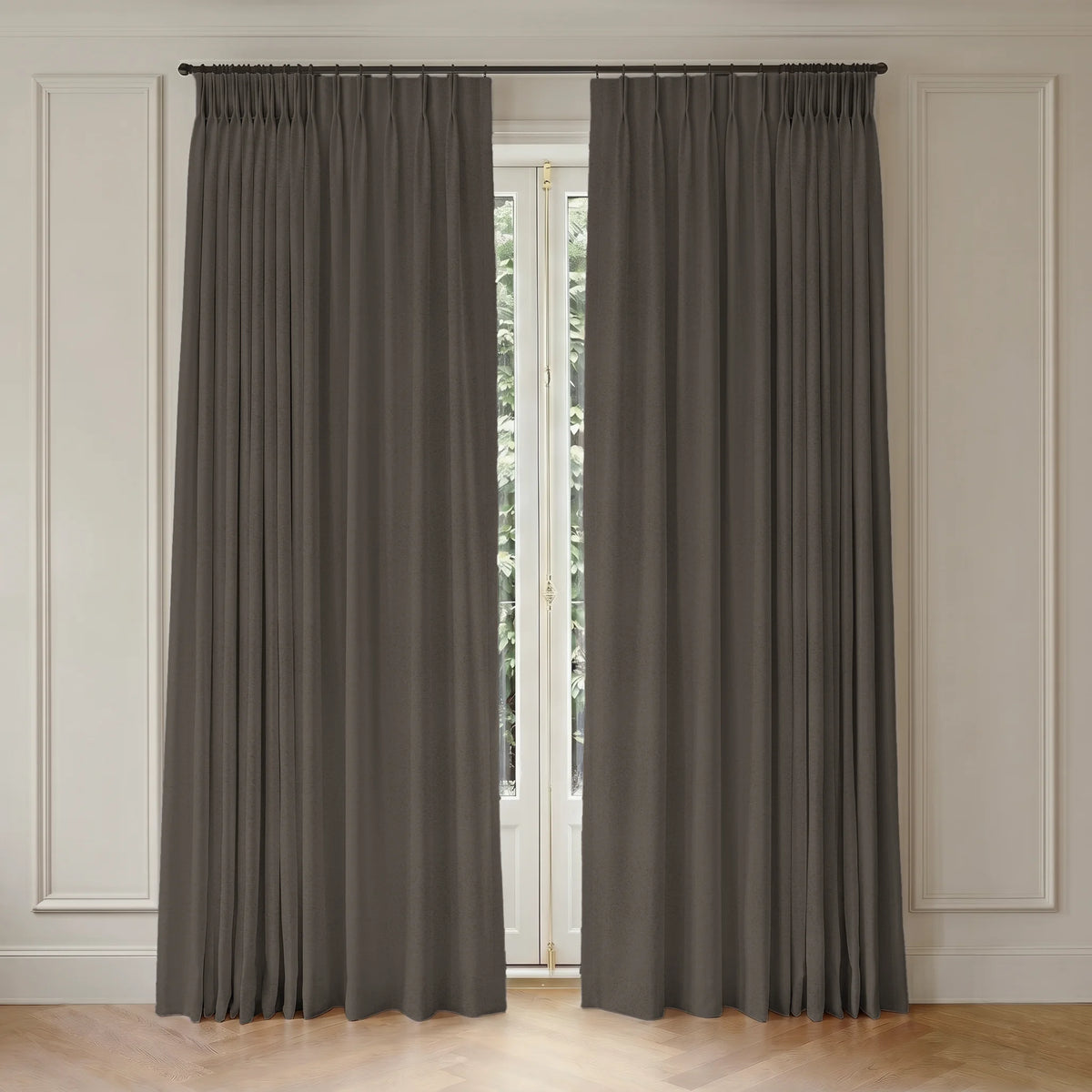 Pair of room darkening curtains hanging in front of a window with white trim.