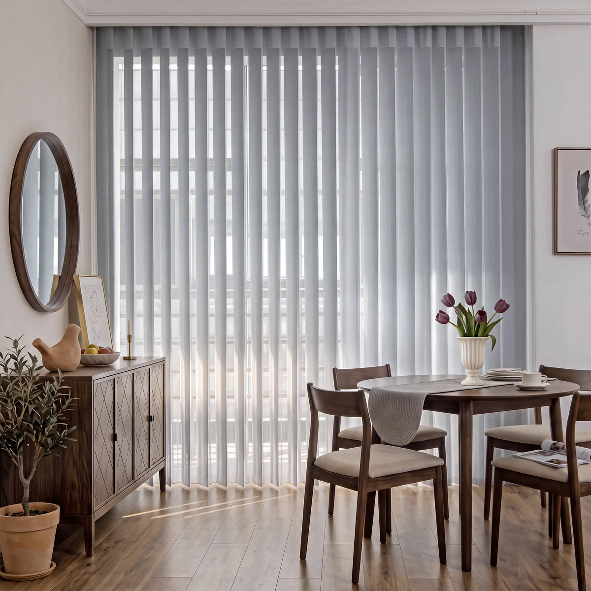 A pair of light gray Smart Sheer Vertical Blinds hanging on a large window in a modern dining room with a wooden table, chairs, and a sideboard.