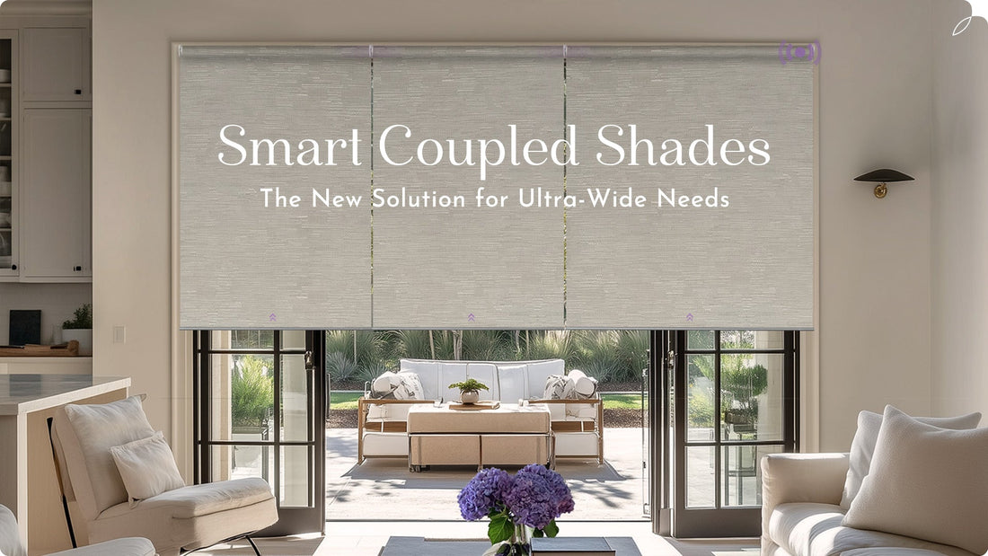Living room with large smart coupled window shades covering glass doors, modern neutral decor.