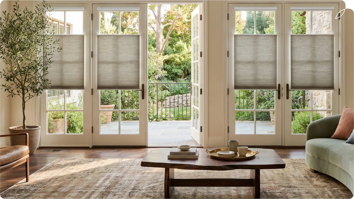 The modern living room features French doors and bottom-up cellular shades.