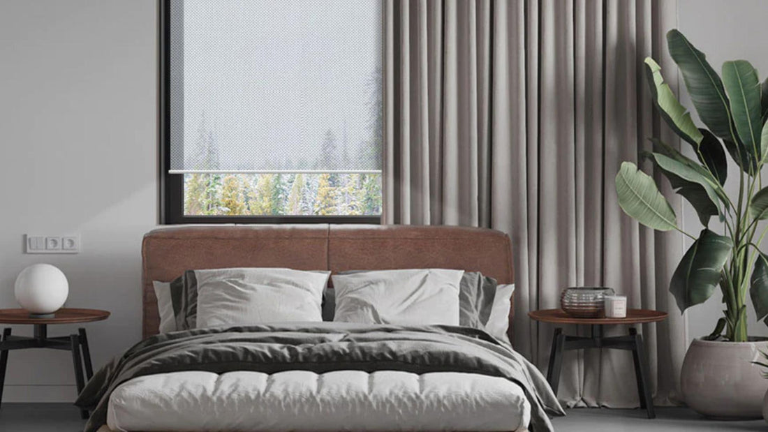 Modern bedroom with graywind blackout curtains, a roller shade, and minimalist decor