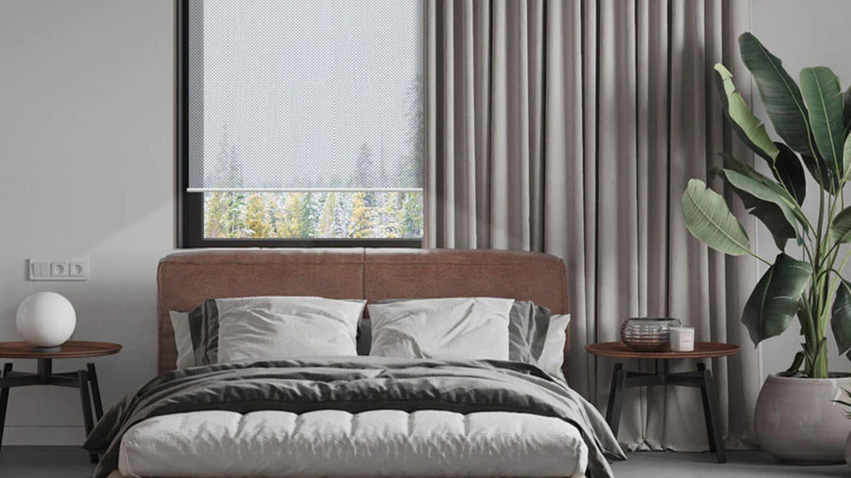 Modern bedroom with graywind blackout curtains, a roller shade, and minimalist decor