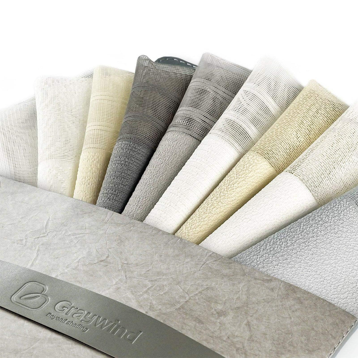 Assorted fabric swatches in neutral tones for custom window treatments
