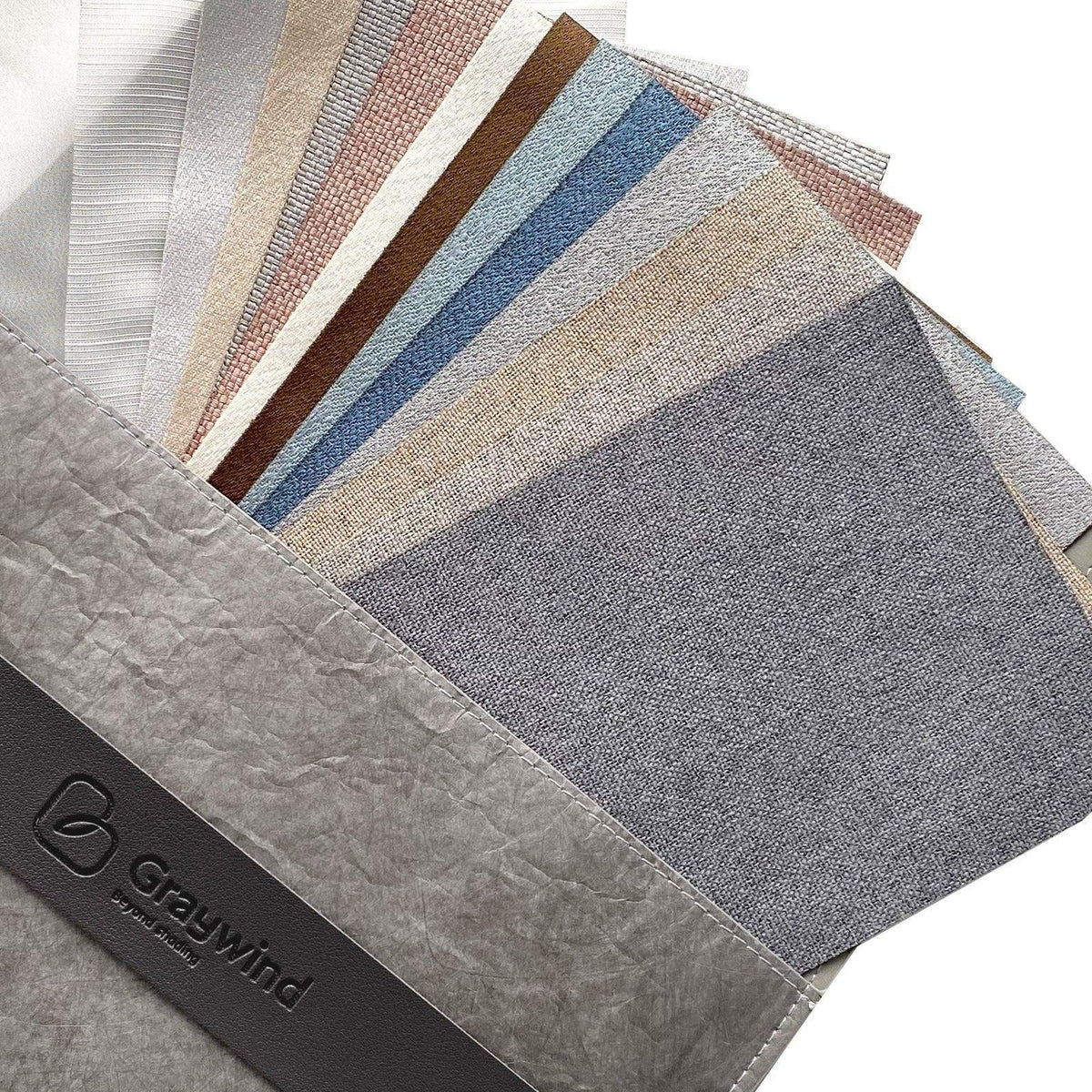 Assorted fabric swatches for custom window treatments in various colors and textures