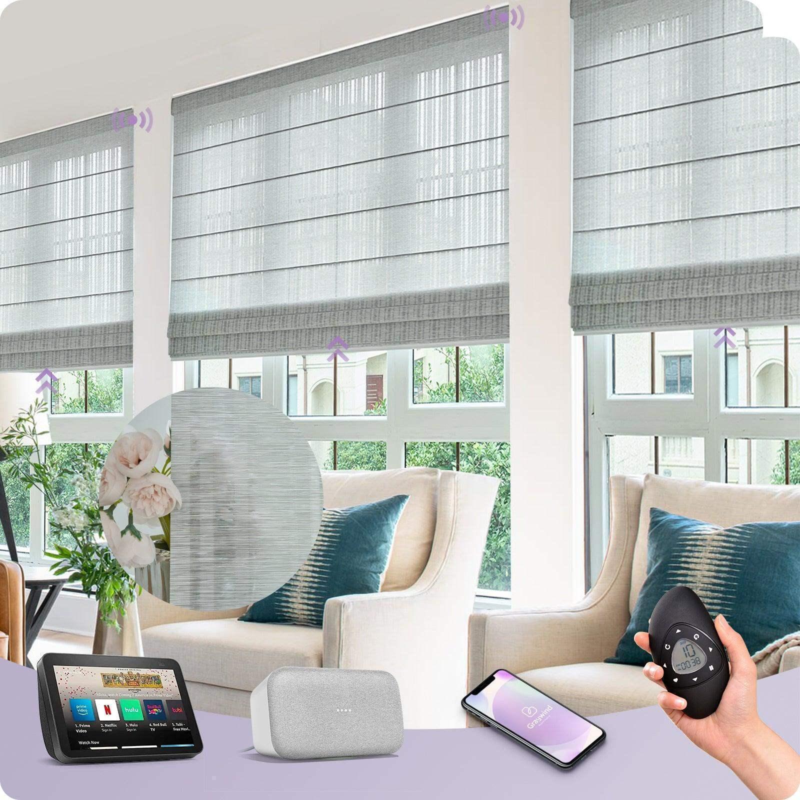 Smart gray Roman shades on large windows in a modern living room, controlled by app, remote, and smart home devices.