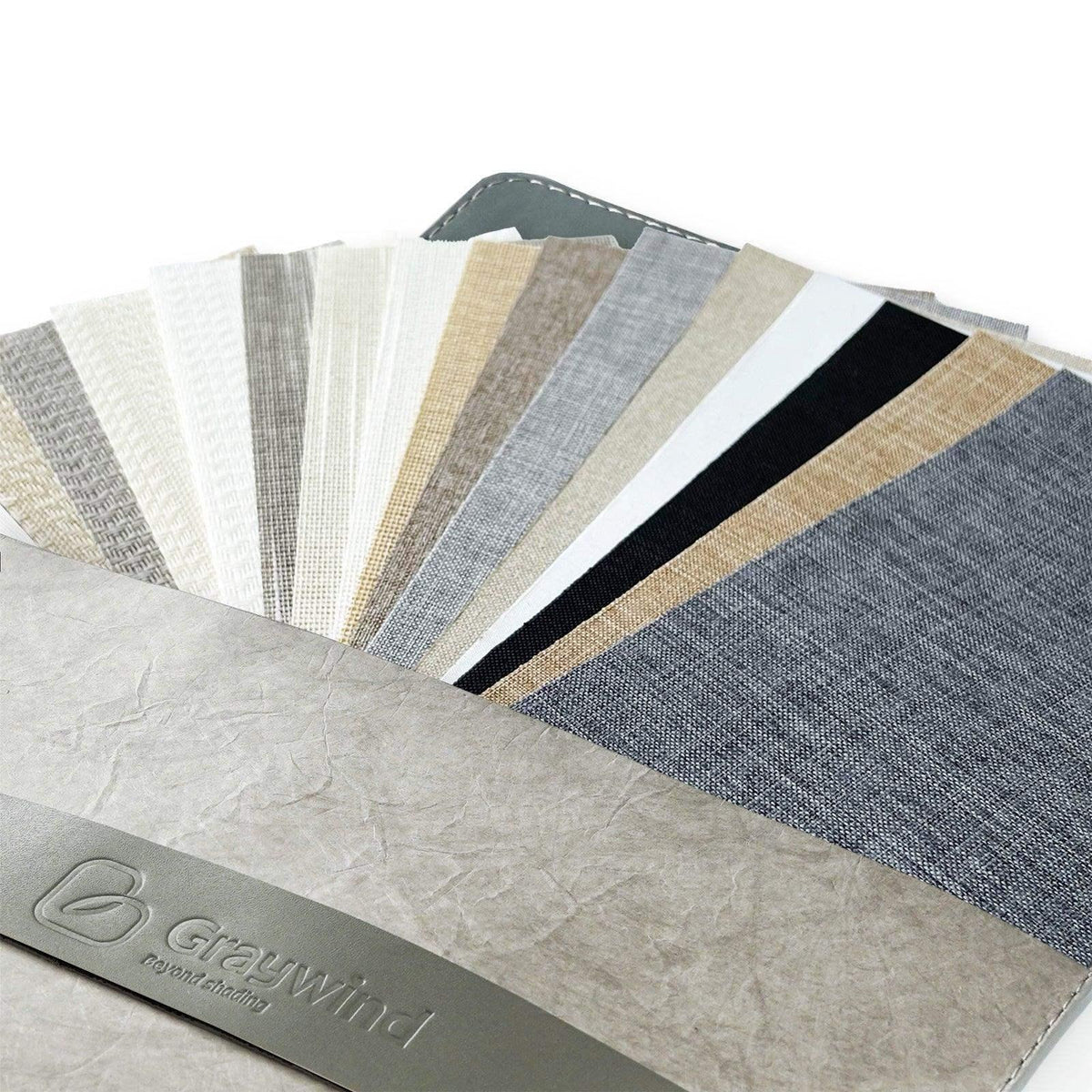 Assorted fabric swatches for custom window treatments in neutral and gray tones