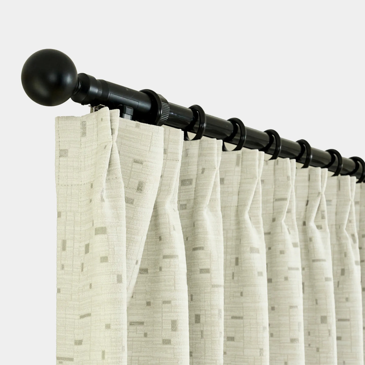 Curtain rod with beige curtains on a white background