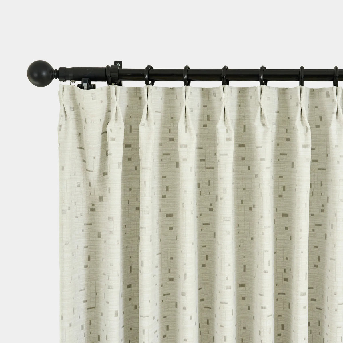 White textured curtain with black rod on a light gray background