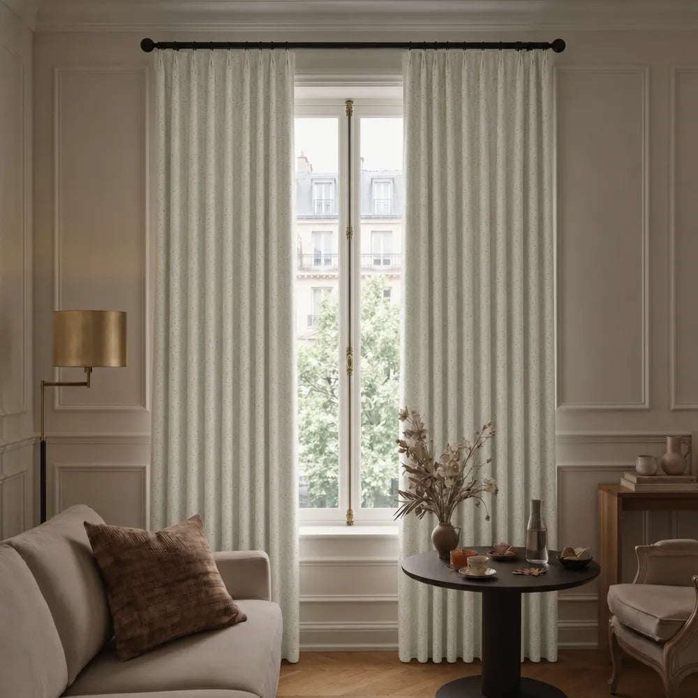Living room with beige sofa, striped curtains, and a small table with decor items.