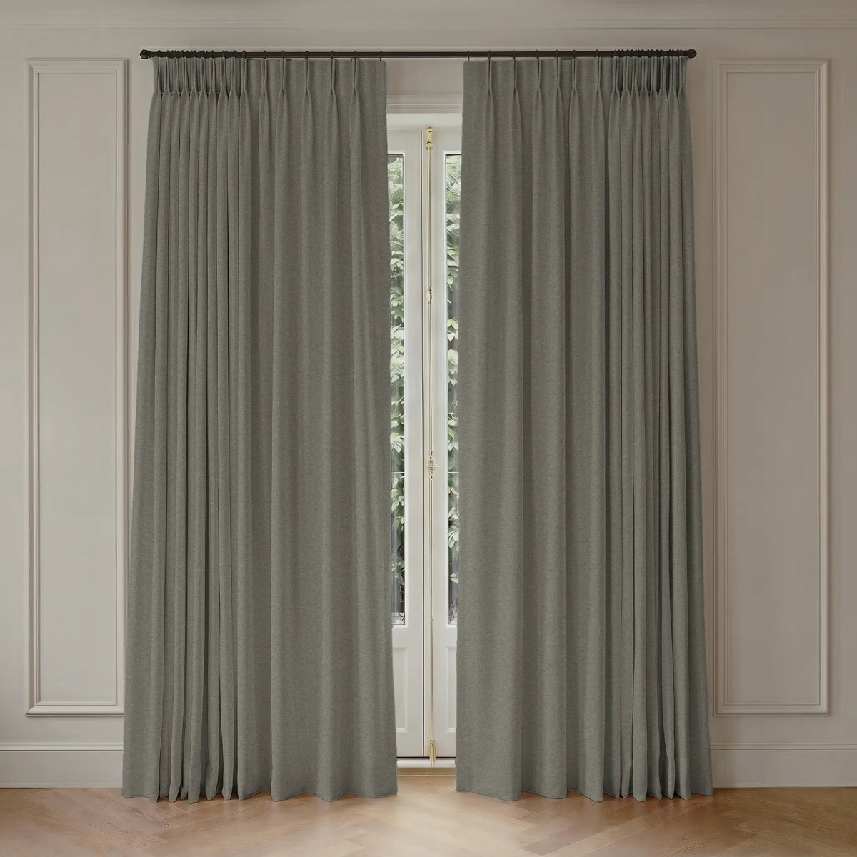 Pair of custom blackout curtains hanging in front of a window with light-colored walls.