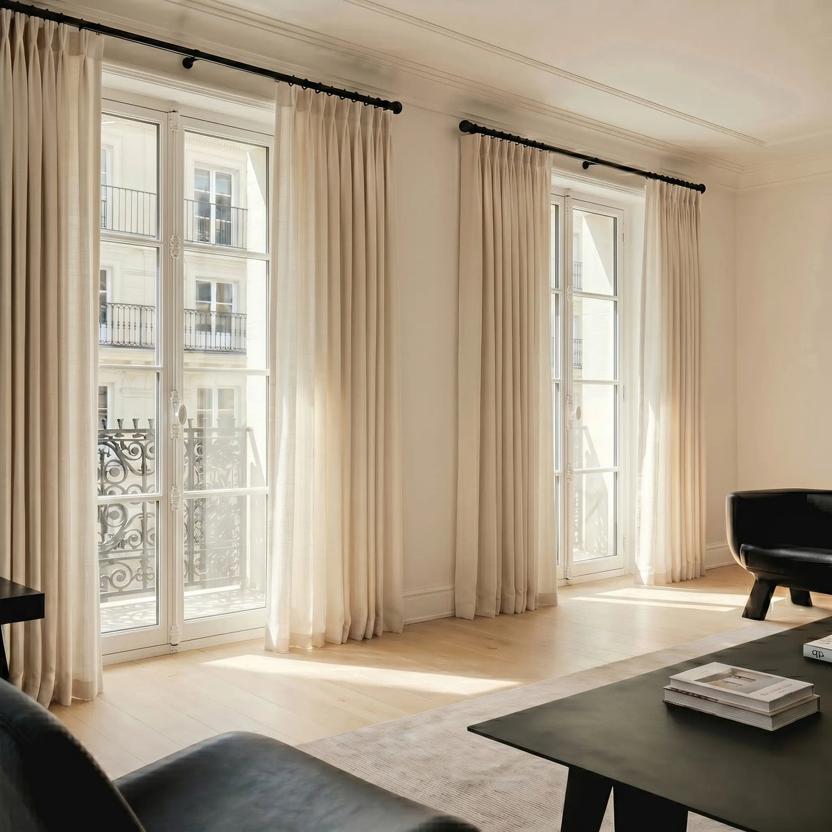 Living room with large windows and sheer curtains with rod.
