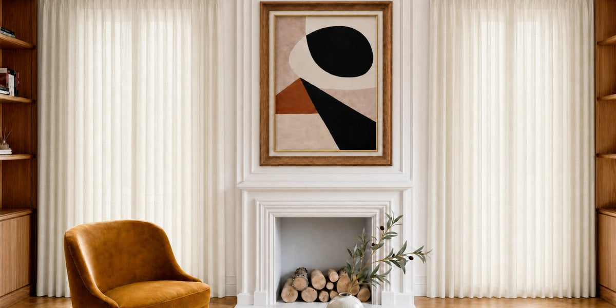 Living room with a brown armchair, abstract art on the wall, and a fireplace.