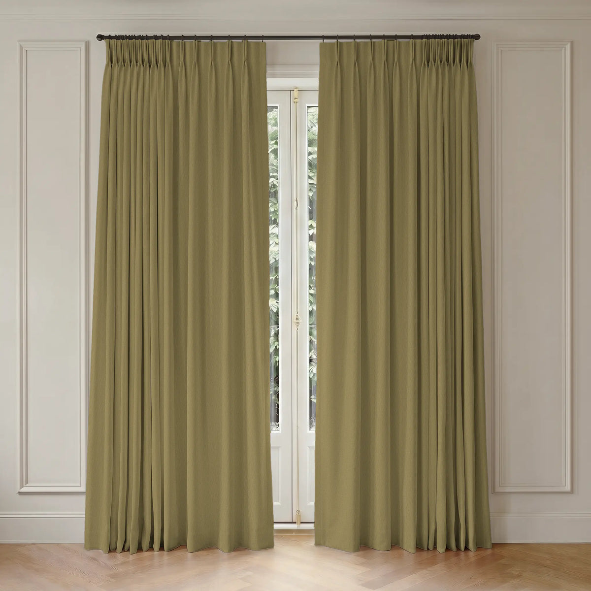 Pair of gold curtains with rod hanging in front of a window with white trim.