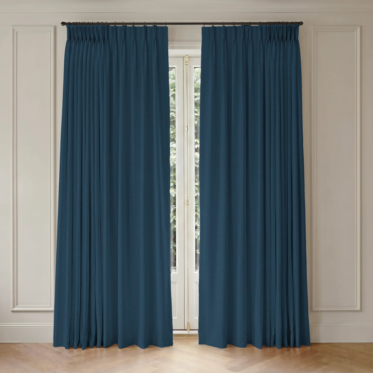 Pair of blue motorized curtains hanging in front of a window with light-colored walls.