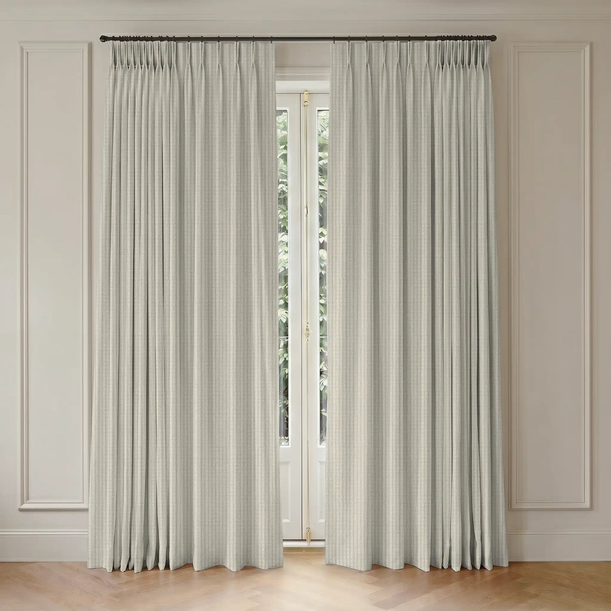 Pair of white  curtains with rod hanging in front of a window with a neutral wall background