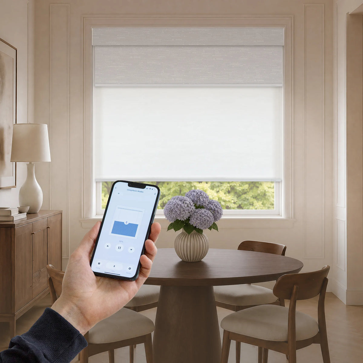 Smart dual roller shades controlled by mobile app in a bright dining room