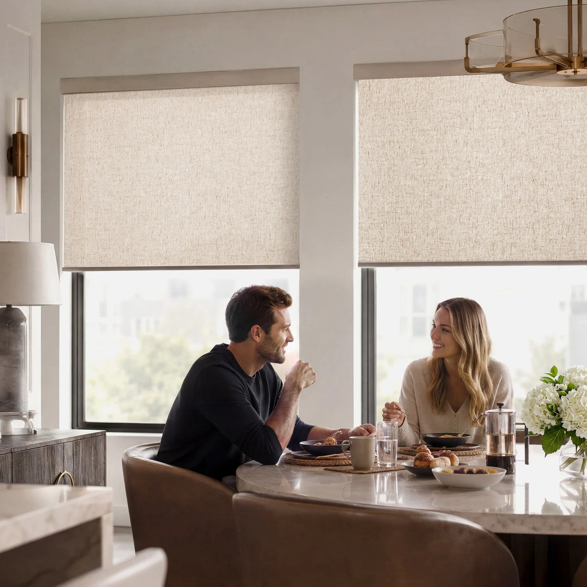 Light filtering roller shades in a bright modern dining room for soft daylight and privacy