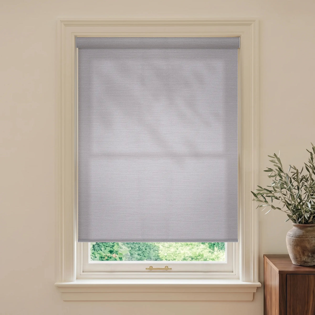 Silky silver grey light filtering roller shades with a smooth refined fabric finish