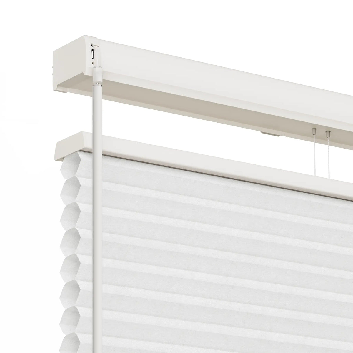 White Motionblinds Smart Top Down Bottom Up Cellular Shades with a hexagonal pleated design, shown partially rolled up with its white metal header rail and suspension cords.