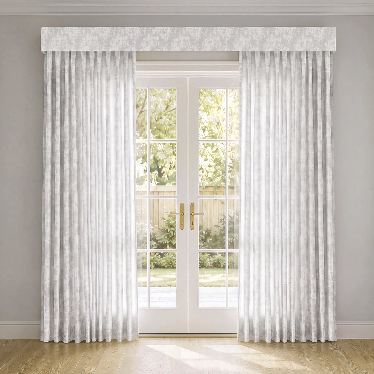 A pair of floor-length white Motorizd Light Filtering  Curtain with a subtle textured pattern, hanging on either side of white French doors with a matching white valance, set in a room with light gray walls and a wooden floor.
