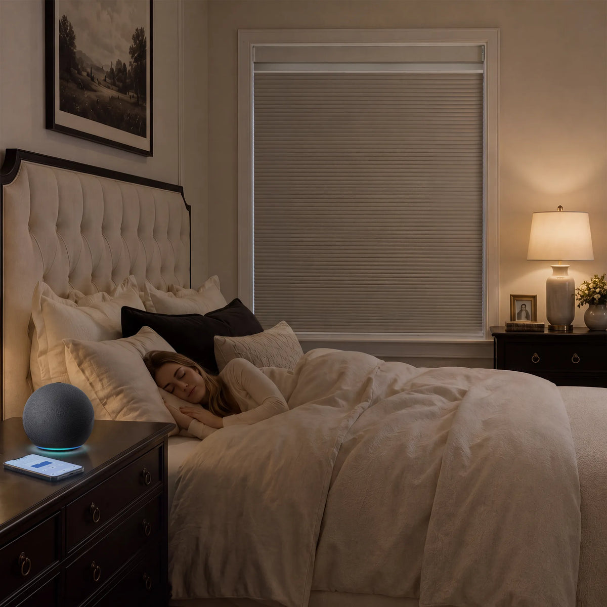 A person sleeping in a bed with beige bedding in a warmly lit bedroom, with a dark round smart speaker on the bedside table in the foreground.