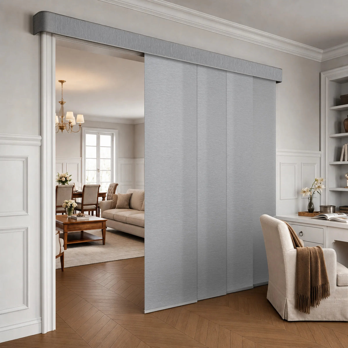 Light gray fabric Motorized Light Filtering Panel Track Blinds installed in a white interior doorway, with a living room visible on the left and a home office area on the right.
