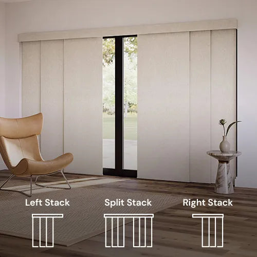 Beige Motorized Panel Track Blinds installed in a modern room with a wooden floor, a tan lounge chair, and a small side table. White line drawings at the bottom label the door sections as Left Stack, Split Stack, and Right Stack.