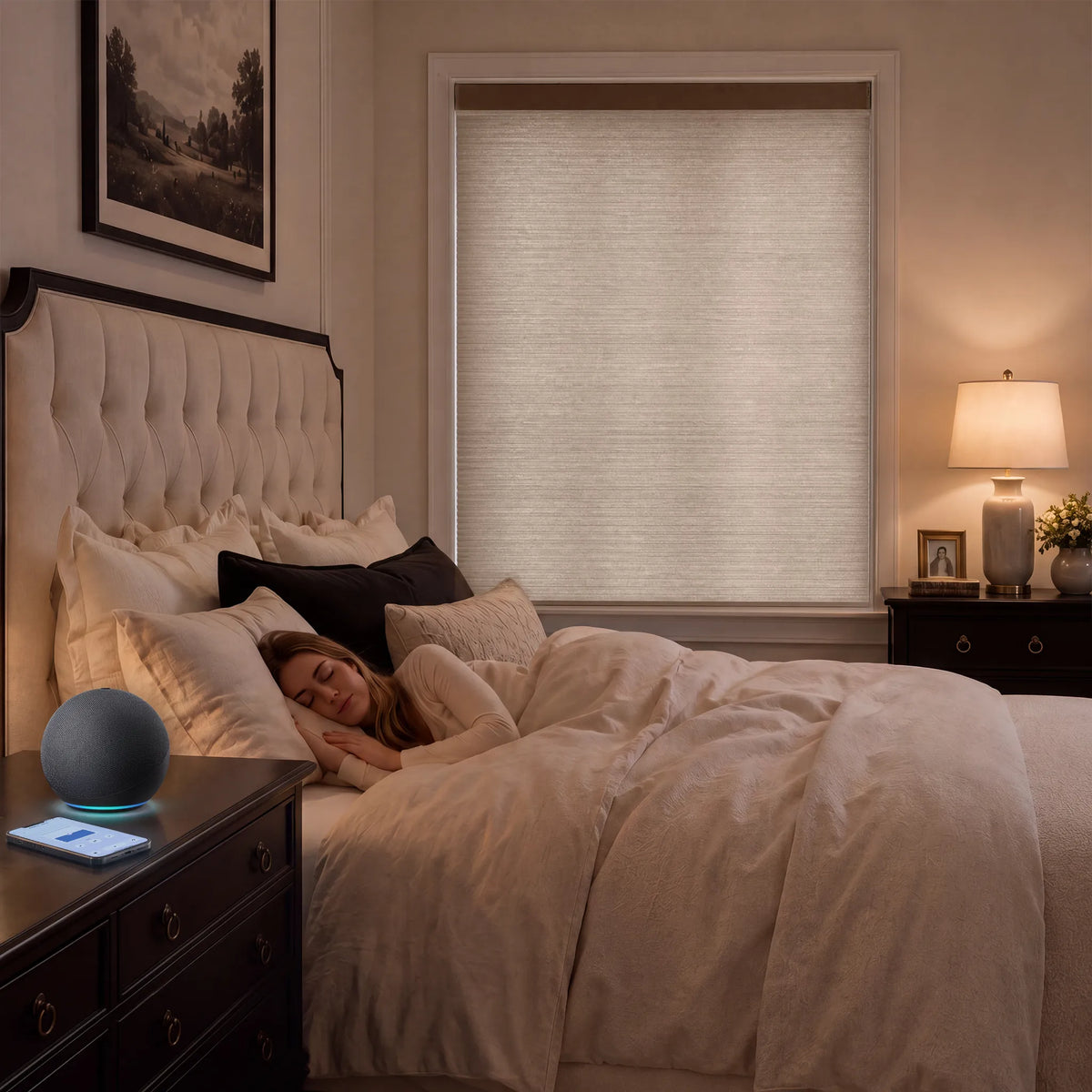 A person sleeping under a light beige textured Motorized Top Down Bottom Up Cellular Shades  on a window in a cozy, warmly lit bedroom.