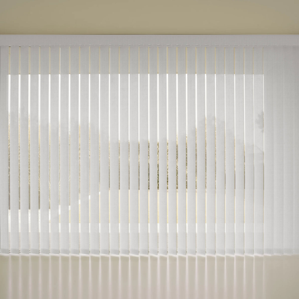 White Smart Vertical Blinds  hanging in front of a window, with soft light filtering through and a beige wall visible above.