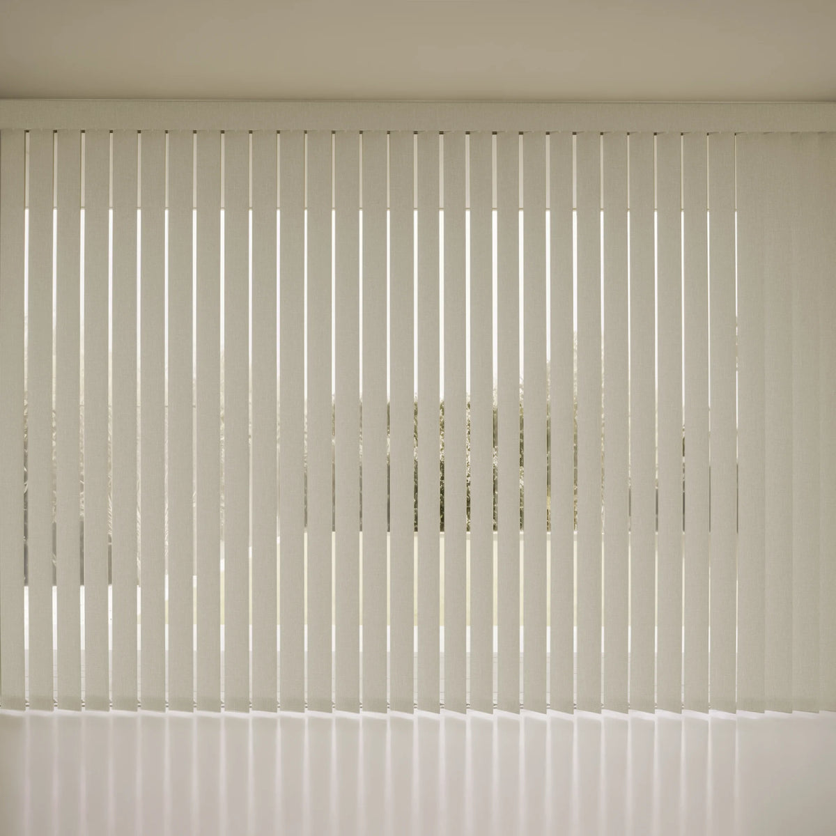 White beige Smart Vertical Blinds covering a window, casting soft vertical shadows on a light-colored wall and floor.