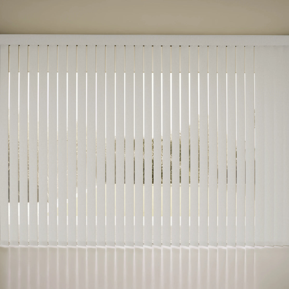 White Smart Vertical Blinds  slat window blinds covering a window, with a beige wall and floor visible.
