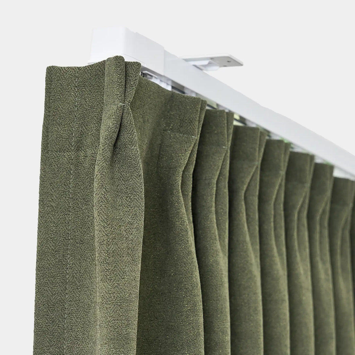 Green pleated curtain on a white rod against a white background