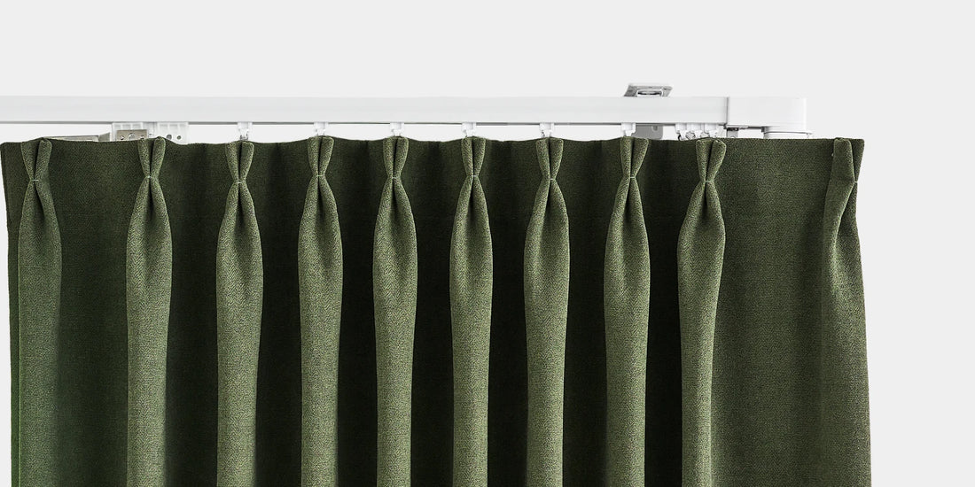 Green pleated curtain on a white background