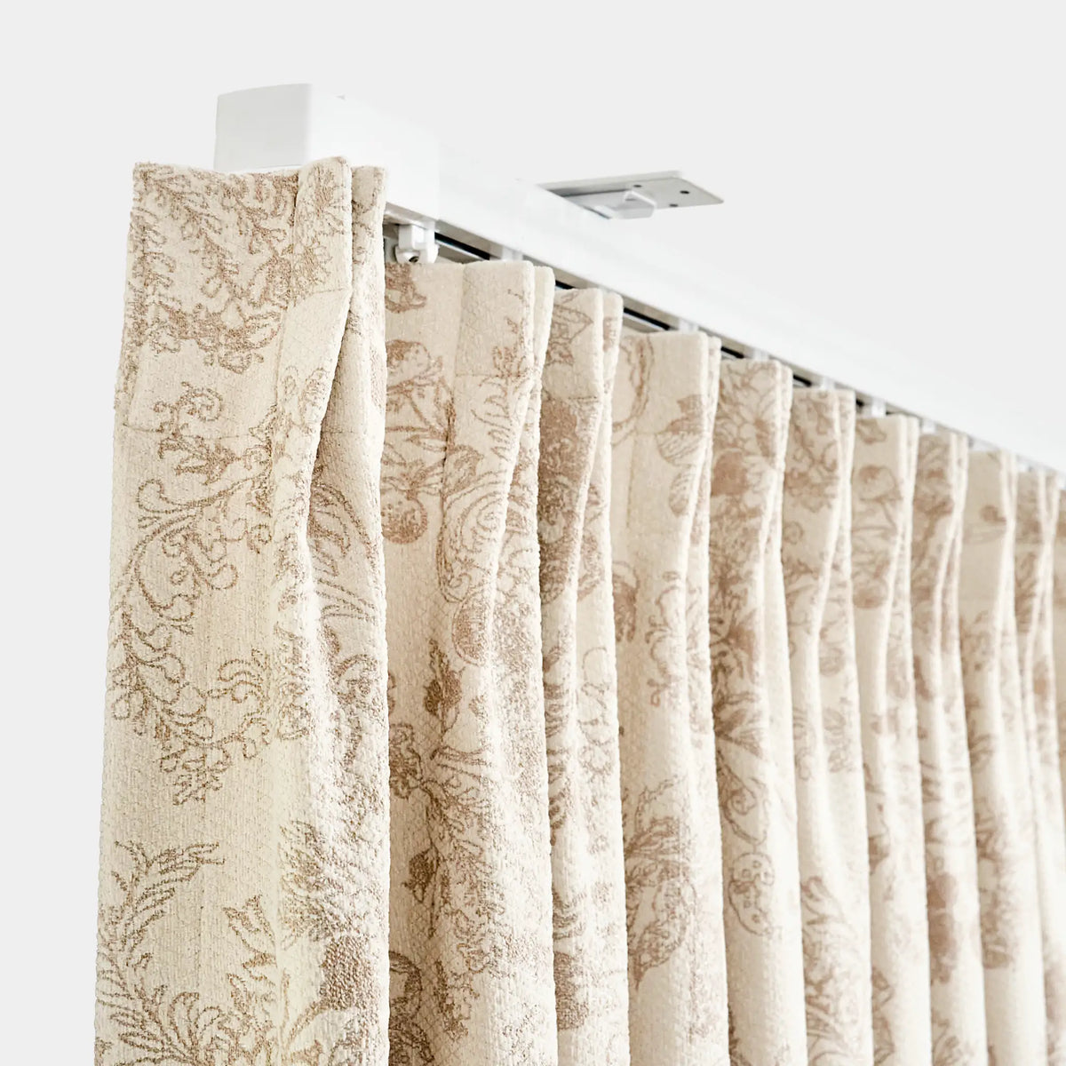 Beige patterned curtains on a white background