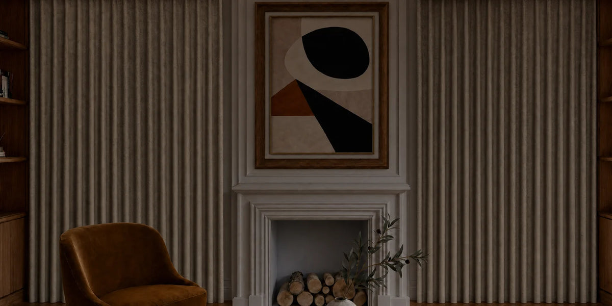 Living room with a brown armchair, abstract art above a fireplace, and striped wallpaper.