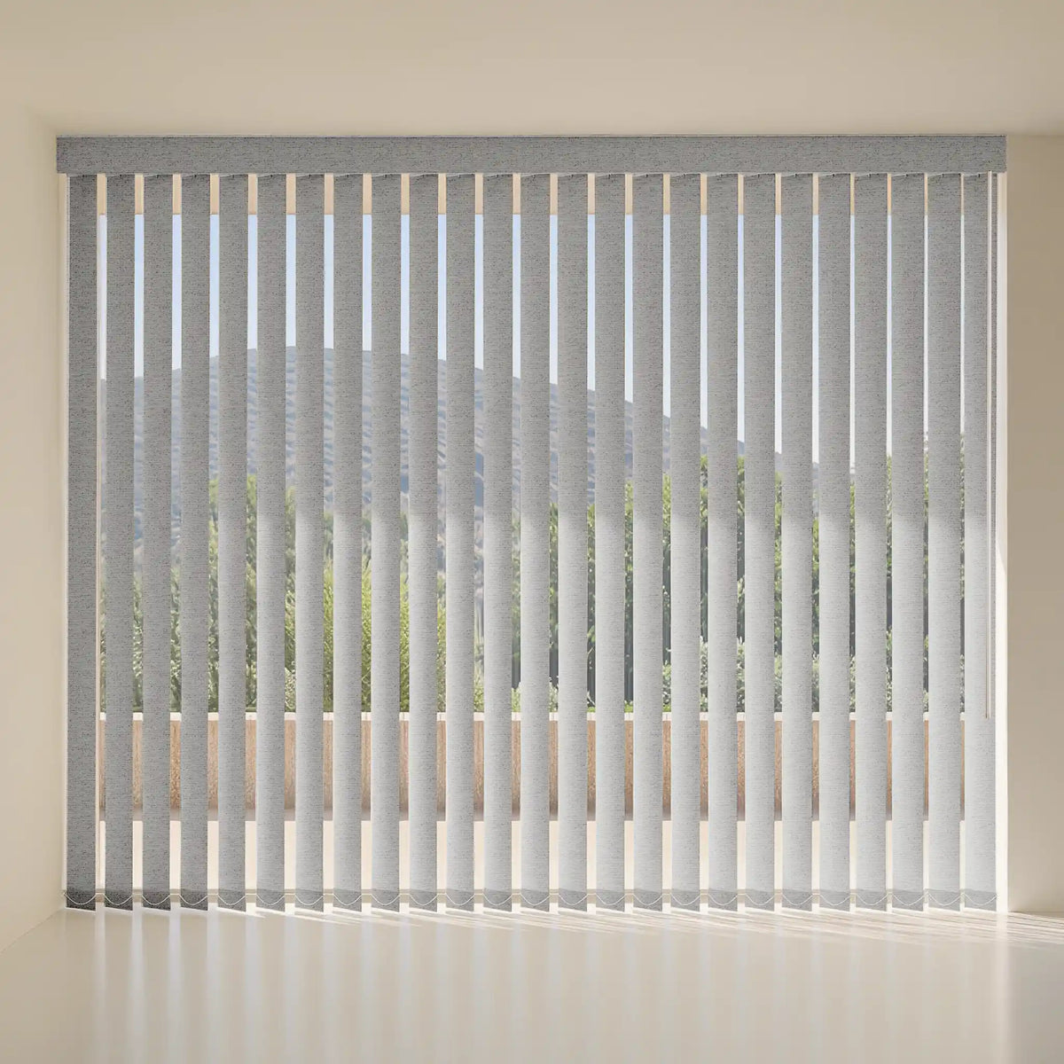 Gray vertical blind curtains with a subtle pattern, shown hanging in front of a window in a minimalist room setting.