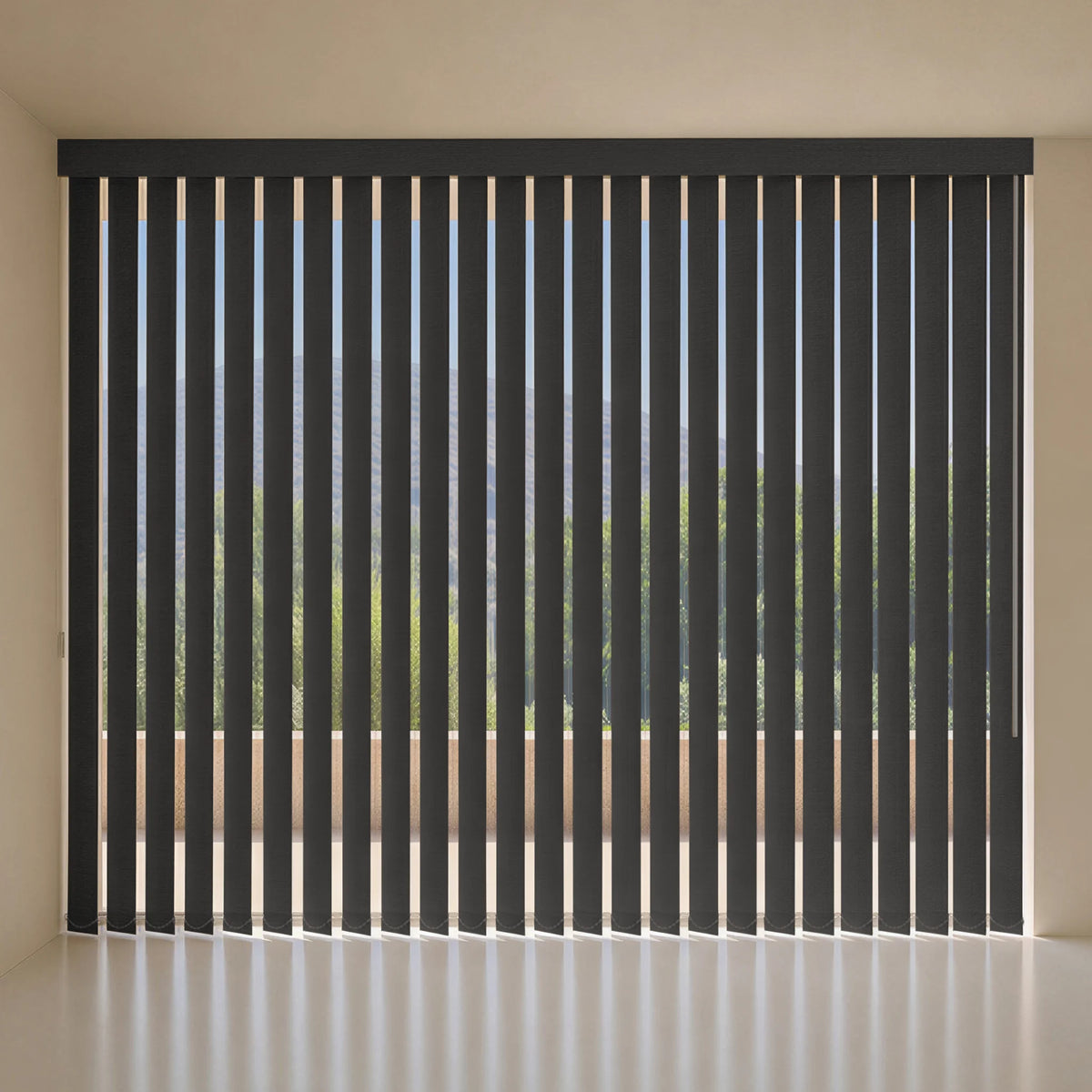 Black vertical blind treatments installed on a large window, shown in a minimalist room with beige walls and a light floor.