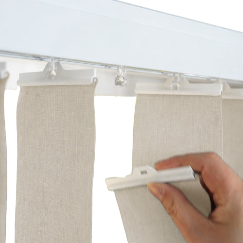 A close-up of a hand holding a white panel clip and repalcing a panel of Vertical Blinds.