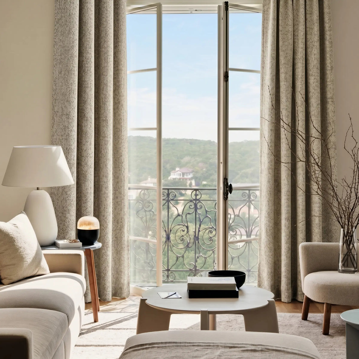 Living room with large windows, blackout curtains with rod, and a view of greenery outside.