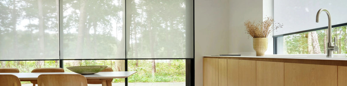 Kitchen interior with roller blinds and wooden furniture