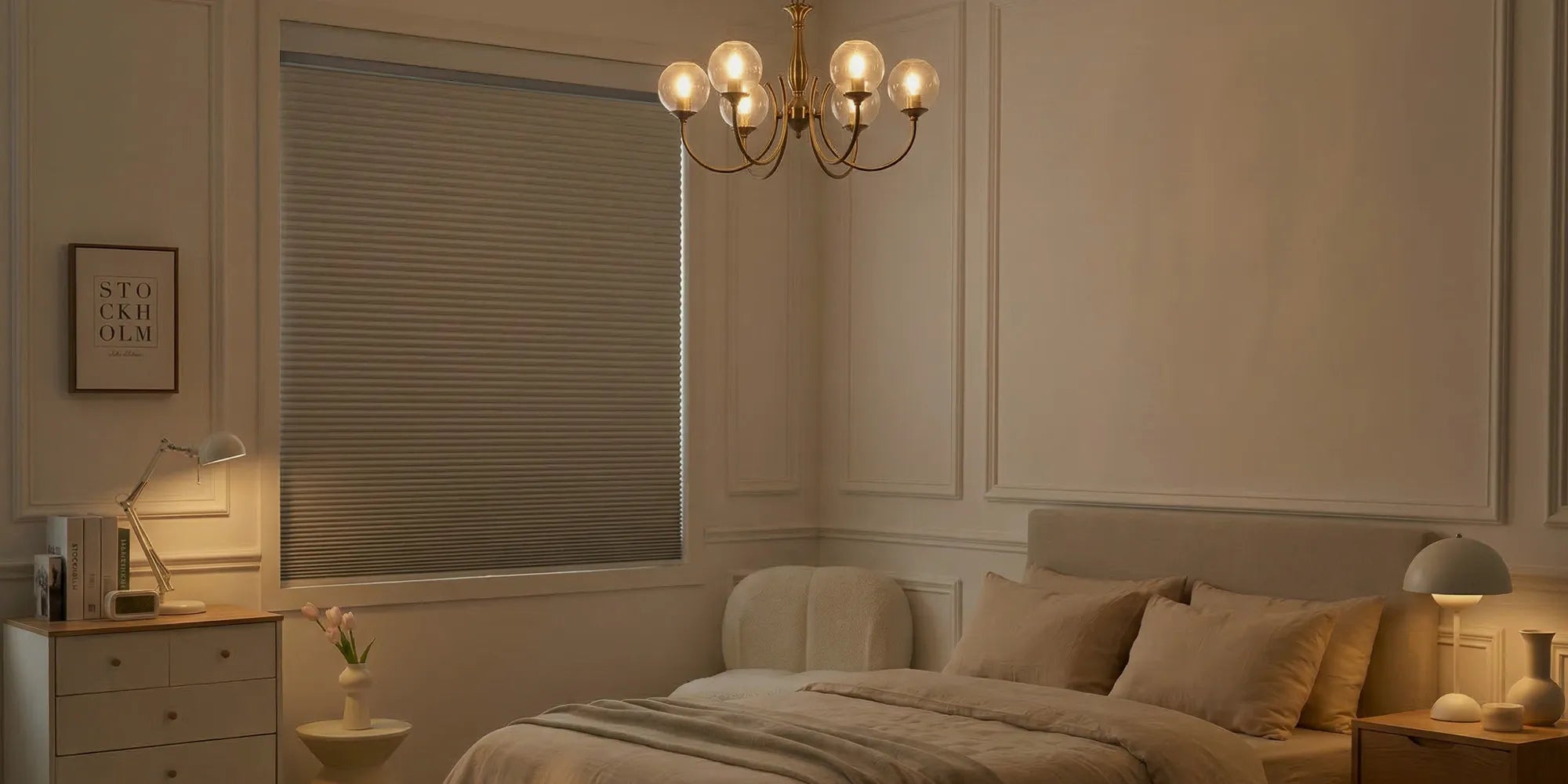 Cozy bedroom with a chandelier, bed, and cellular shades.