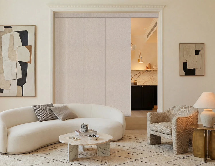  A fancy living room with white sofa and sliding panel blinds.