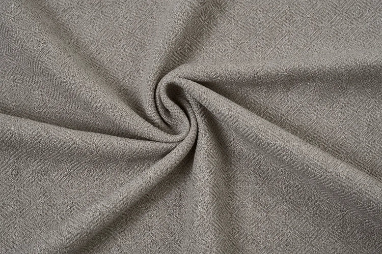 A close-up of textured fabric swirled in the center, showing a fine herringbone weave in a warm gray or taupe color.