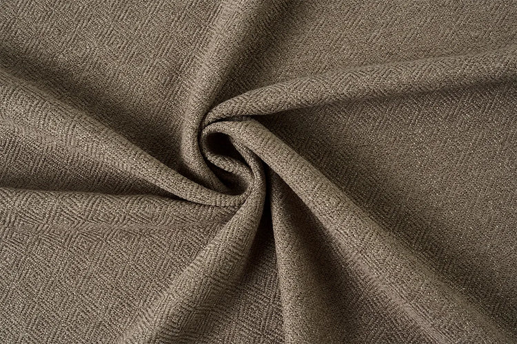 A close-up of draped fabric with a fine herringbone or basketweave texture in a warm taupe-brown color, arranged in a spiral fold.