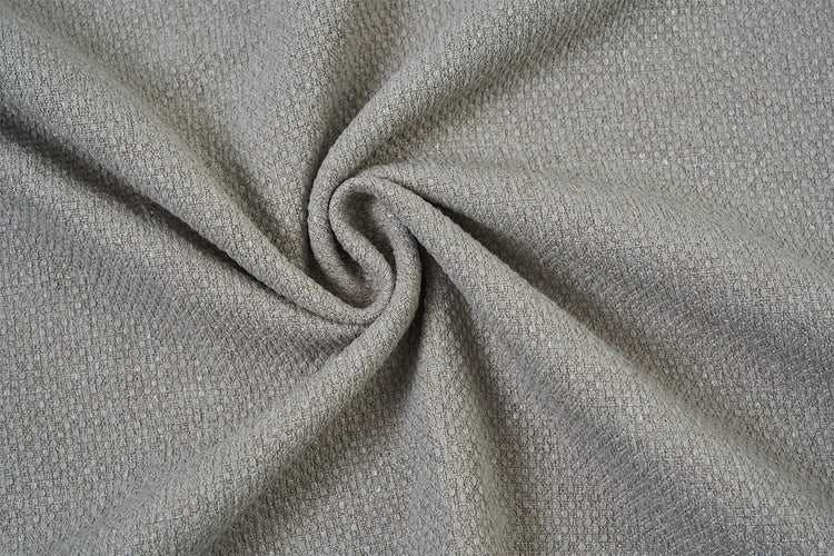 A close-up of textured fabric swirled in the center, showing a fine woven pattern in a light warm gray or taupe tone.