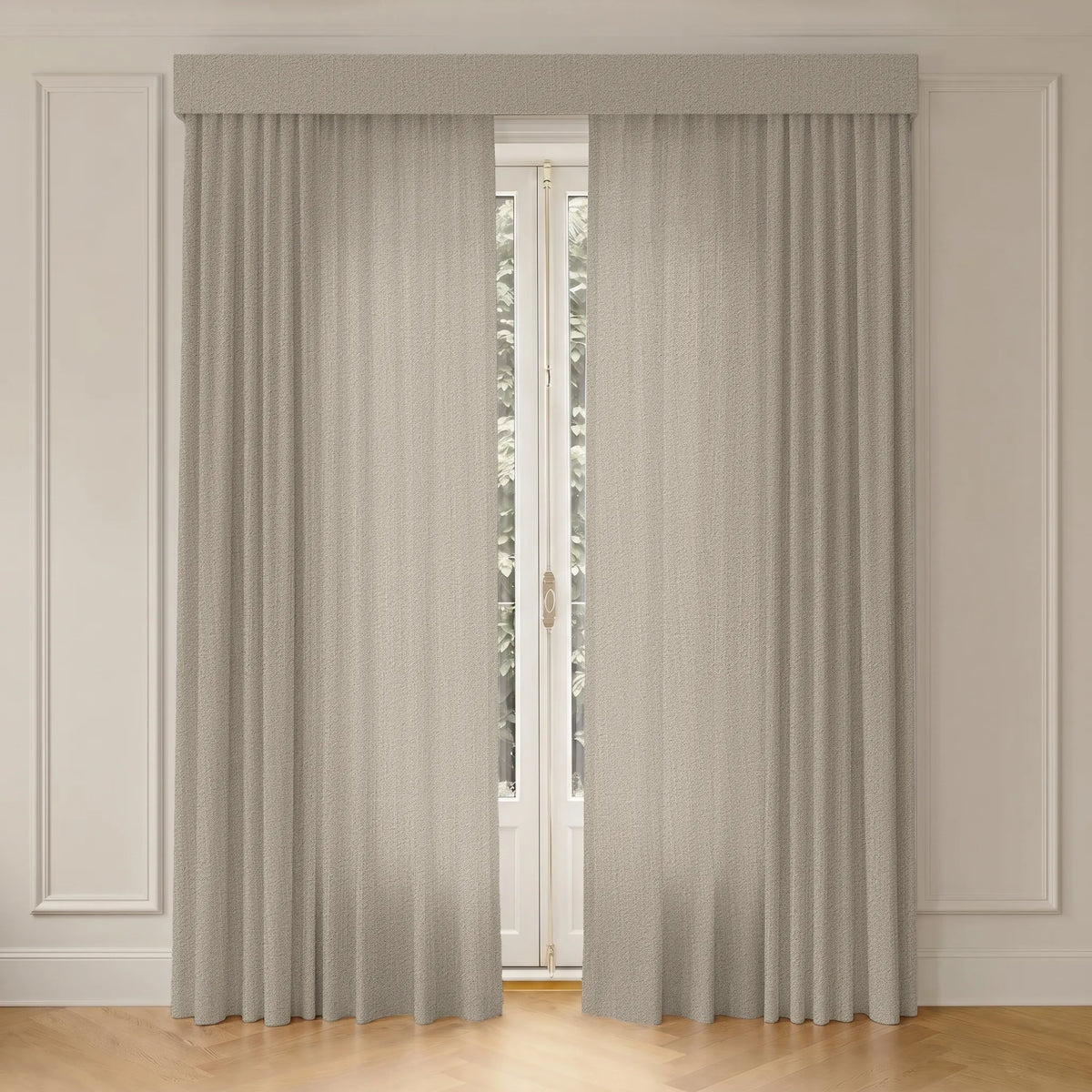 A pair of light beige textured window curtains with a matching fabric valance, hanging in front of a white French door on a light wood floor against a white paneled wall.