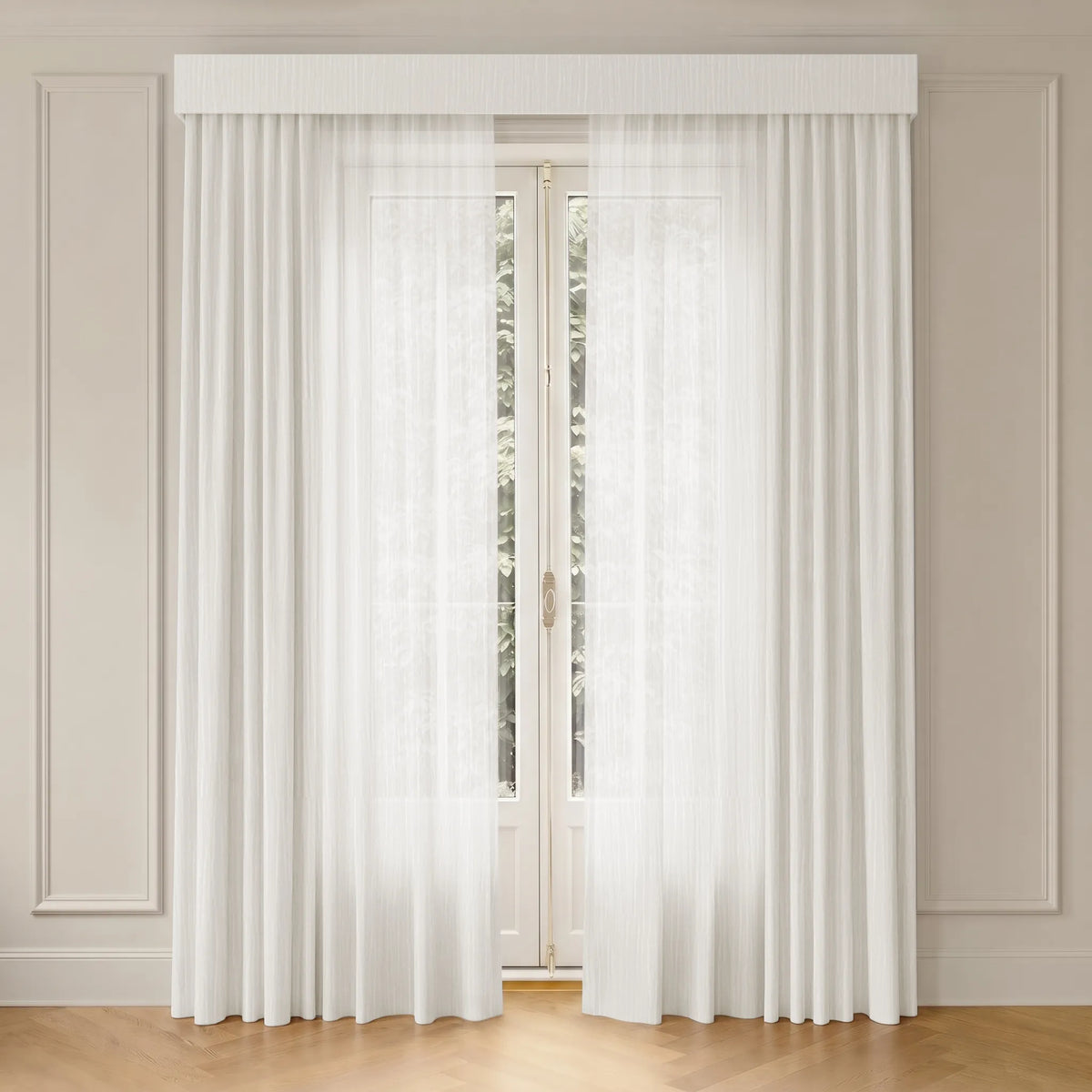White sheer curtain panels hanging from a white rod, framing a tall window in a beige paneled room with a light wood floor.