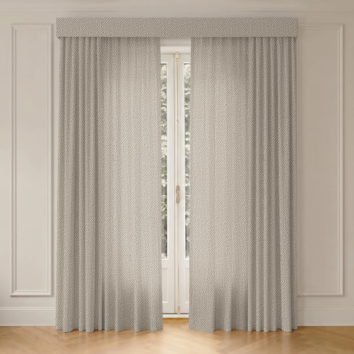 A pair of light gray textured curtains with a matching valance hanging on a white French door in a room with white paneled walls and a light wood floor.