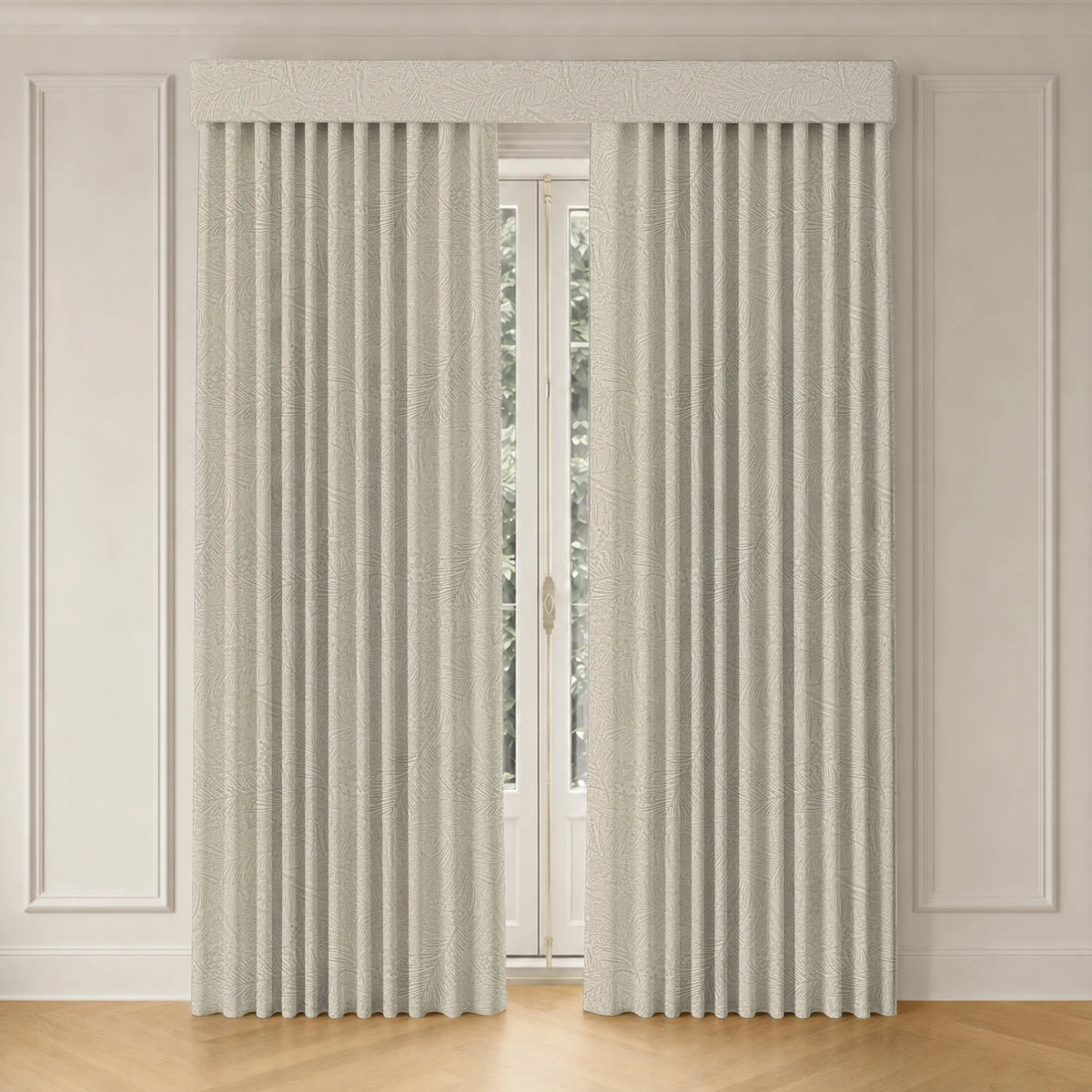 A pair of light beige textured window curtains with pleated folds, hanging on a rod with a matching valance in a classic room setting with white paneled walls and a light wood floor.